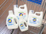 4 all laundry detergent bottles sitting in a walmart cart