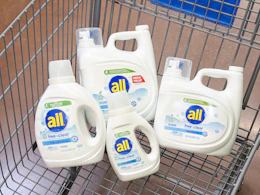 4 all laundry detergent bottles sitting in a walmart cart