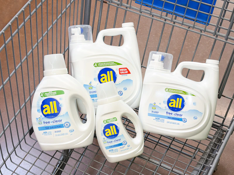 4 all laundry detergent bottles sitting in a walmart cart