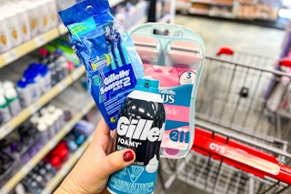 hand holding gillette and venus razors and shave cream