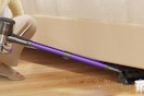 a woman using a cordless vacuum