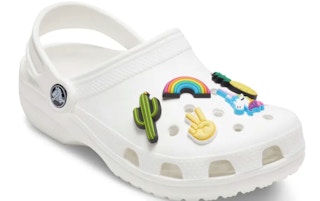 A Crocs classic clog with Jibbitz decorating it.