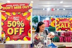 a woman shopping in bath and body works during a sale
