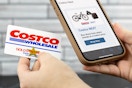 someone holding up their Costco card and phone showing the link to Costco Next websiteNext