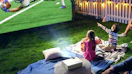 a family watching a football game on a projector outside