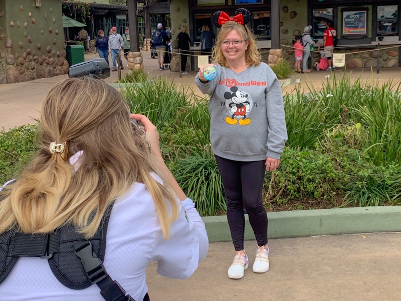 someone holding up a special pin at disney world