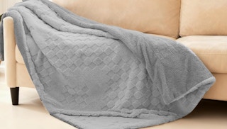 a grey blanket on a couch