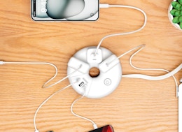 a travel power strip on a table with devices plugged in