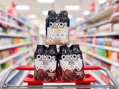 3 oikos protein shakes 4-packs sitting on top a target cart