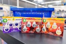 three packs of air wick refills on walmart shelf in front of hand cart