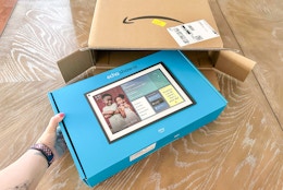 someone taking an echo out of an amazon box