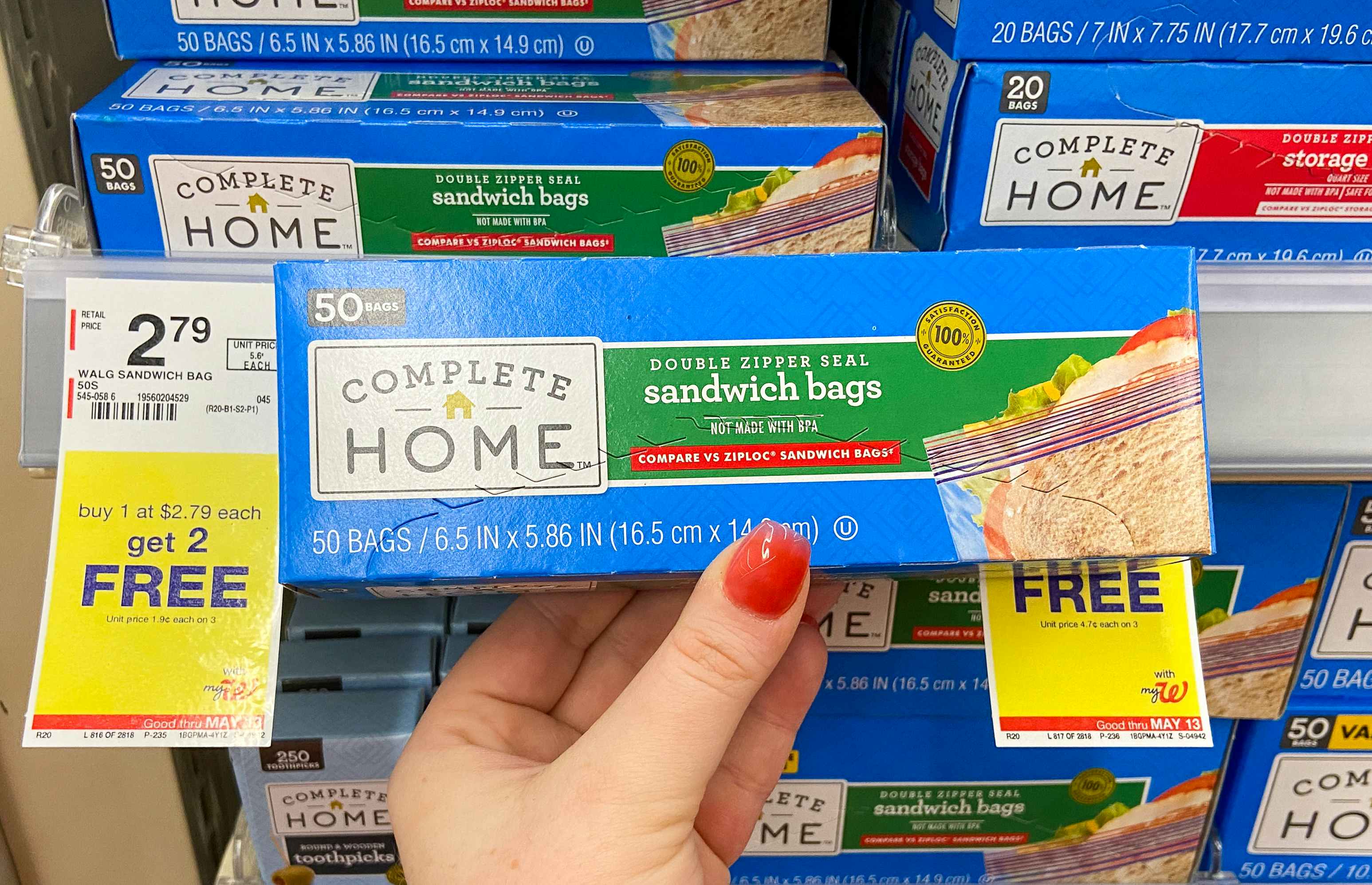 hand holding a box of complete home food storage sandwich bags next to a sale tag at walgreens