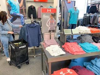 A woman shopping in the Under Armour section inside Kohls