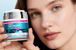 a woman holding scar cream