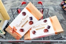 2 boxes of russell stover chocolates in a cart