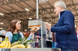 a senior man checking out at a grocery store 