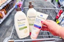 hand holding aveeno lotions in a shopping cart