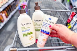hand holding aveeno lotions in a shopping cart