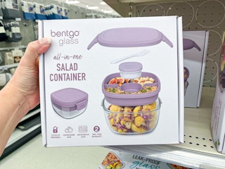 hand holding a Bentgo Salad container with purple lids