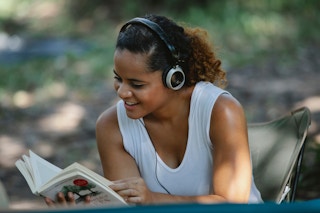 A woman listening to a book with headphones on