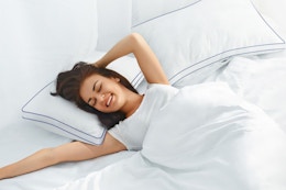 woman laying on pillows in bed