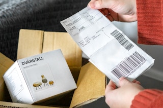 Someone looking at their receipt with their IKEA online order