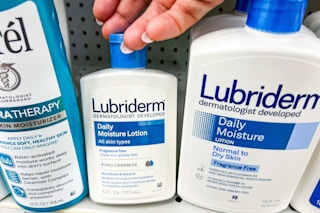 hand grabbing Lubriderm lotion off shelf