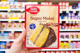 hand holding up a box of betty crocker cake mix