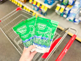 hand holding gum floss picks in cvs