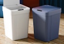 white and blue automatic trash cans