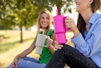 lifestyle image of 2 people holding tumbler water bottles