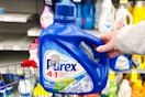 person holding a bottle of purex detergent 
