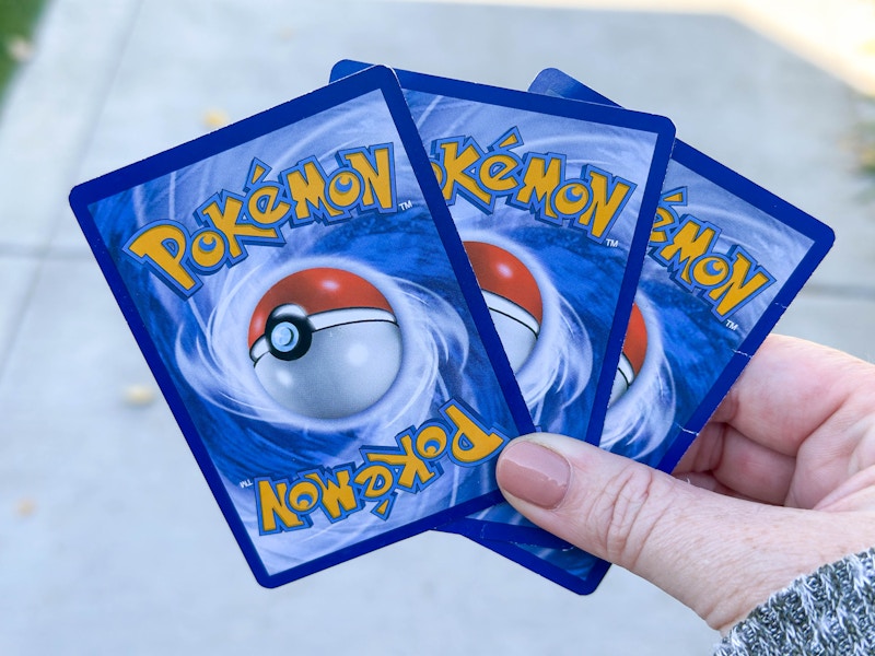 pokemon cards being held 