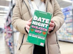 woman holding date night scratch off at walmart