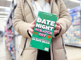 woman holding date night scratch off at walmart