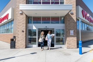 two women walking out of cvs