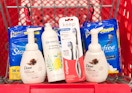 bottles of soap, a toothbrush, and pads in Target shopping cart