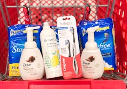 bottles of soap, a toothbrush, and pads in Target shopping cart