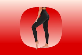 The lower half of a woman wearing fitted, high-waisted black stretch leggings.