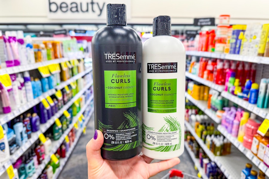 hand holding up two tresemme shampoo and condiitoner at cvs