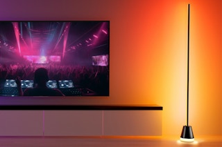 a floor lamp next to a TV