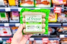 hand holding the 4-pack of Al Fresco chicken sausages