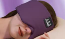 a person sleeping with a purple headphones sleep mask 