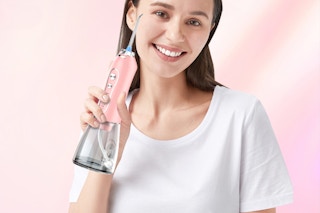 Woman holding Water Dental Flosser