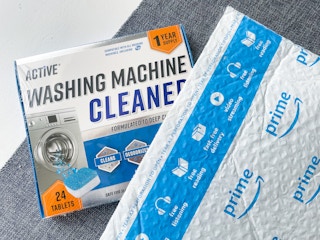active washing machine cleaner next to an amazon prime envelope