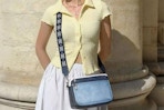 a woman wearing a crossbody bag