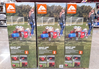 three boxes of Ozark Trail utility cart wagons