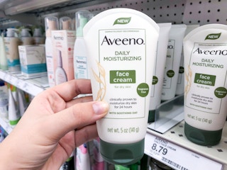hand holding aveeno face cream at target