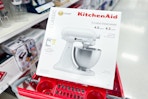 kitchenaid stand mixer sitting on top a target cart