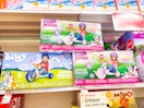 3 fly wheels junior cruisers sitting on a target shelf